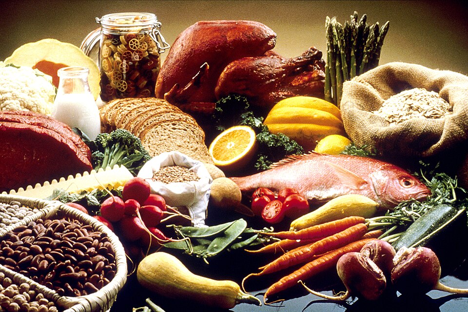 A spread of fresh foods: bread, fish, vegetables and fruit