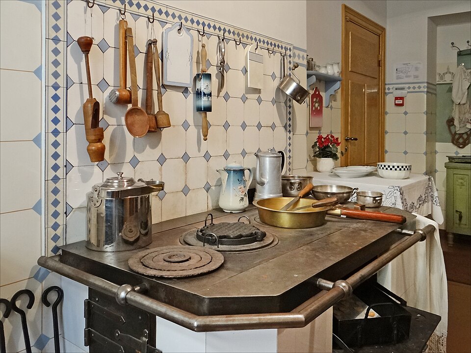 A traditional kitchen with copper pots and utensils
