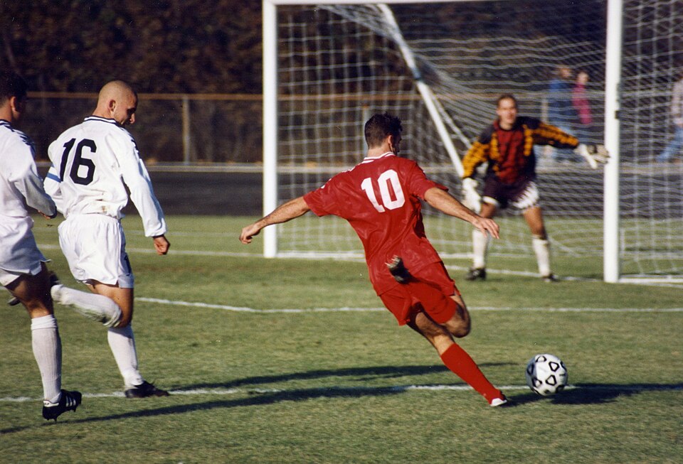 A player shooting at goal in a football match