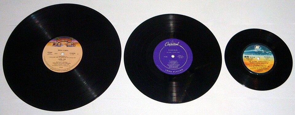 Three vinyl records of different sizes